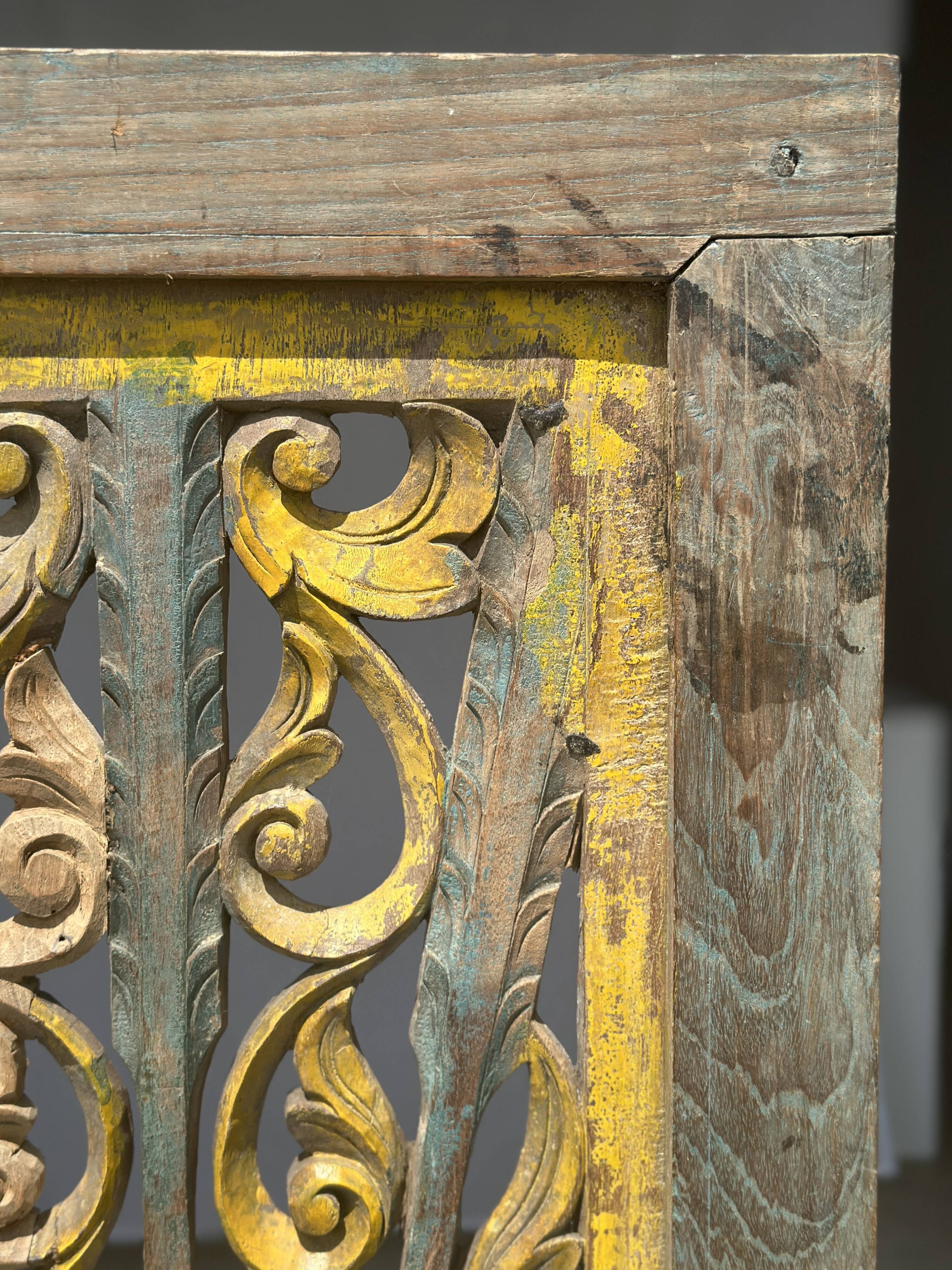 Rectangular Indonesian construction element with blue and yellow plant in carved wood