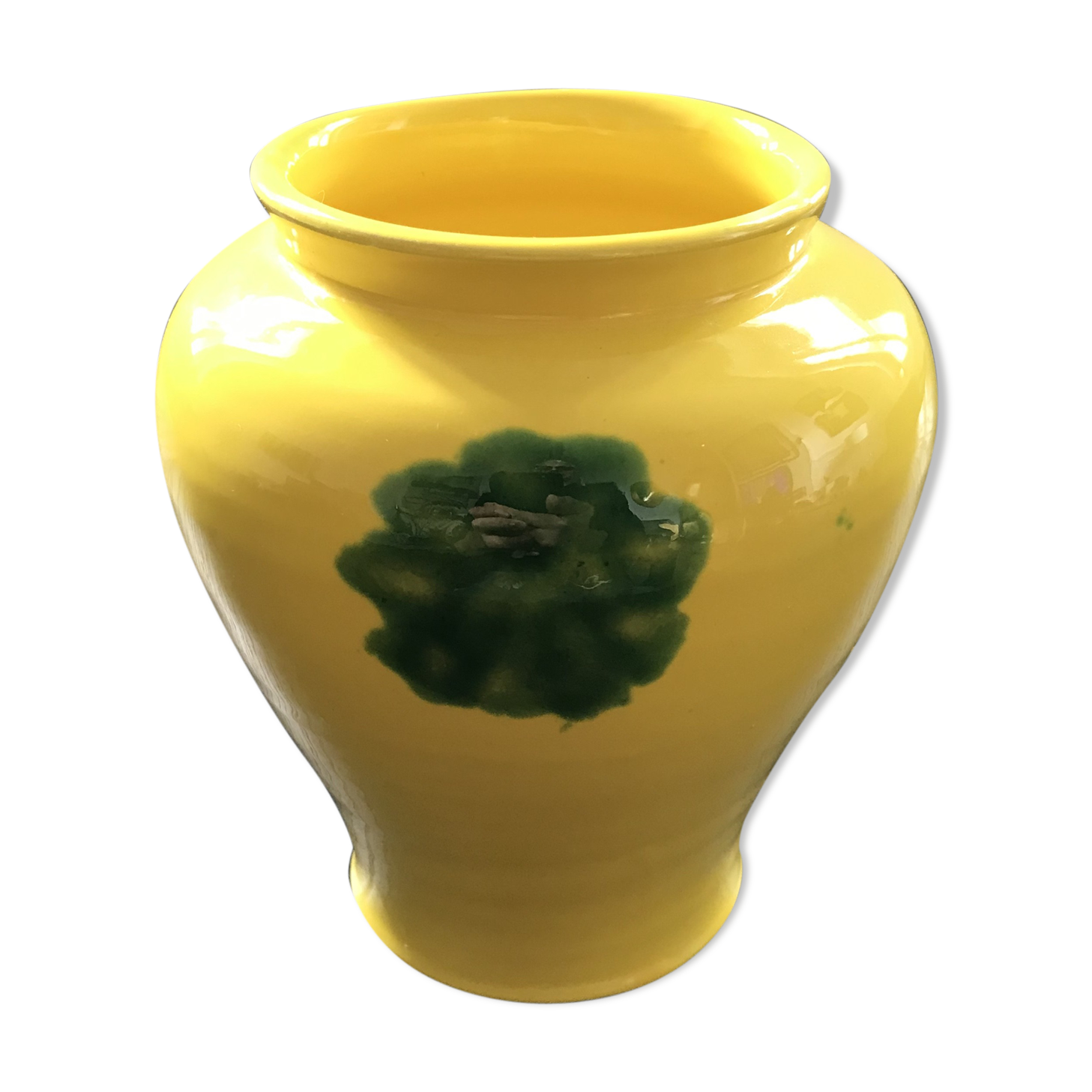 Yellow vase with green spots.