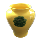 Yellow vase with green spots.