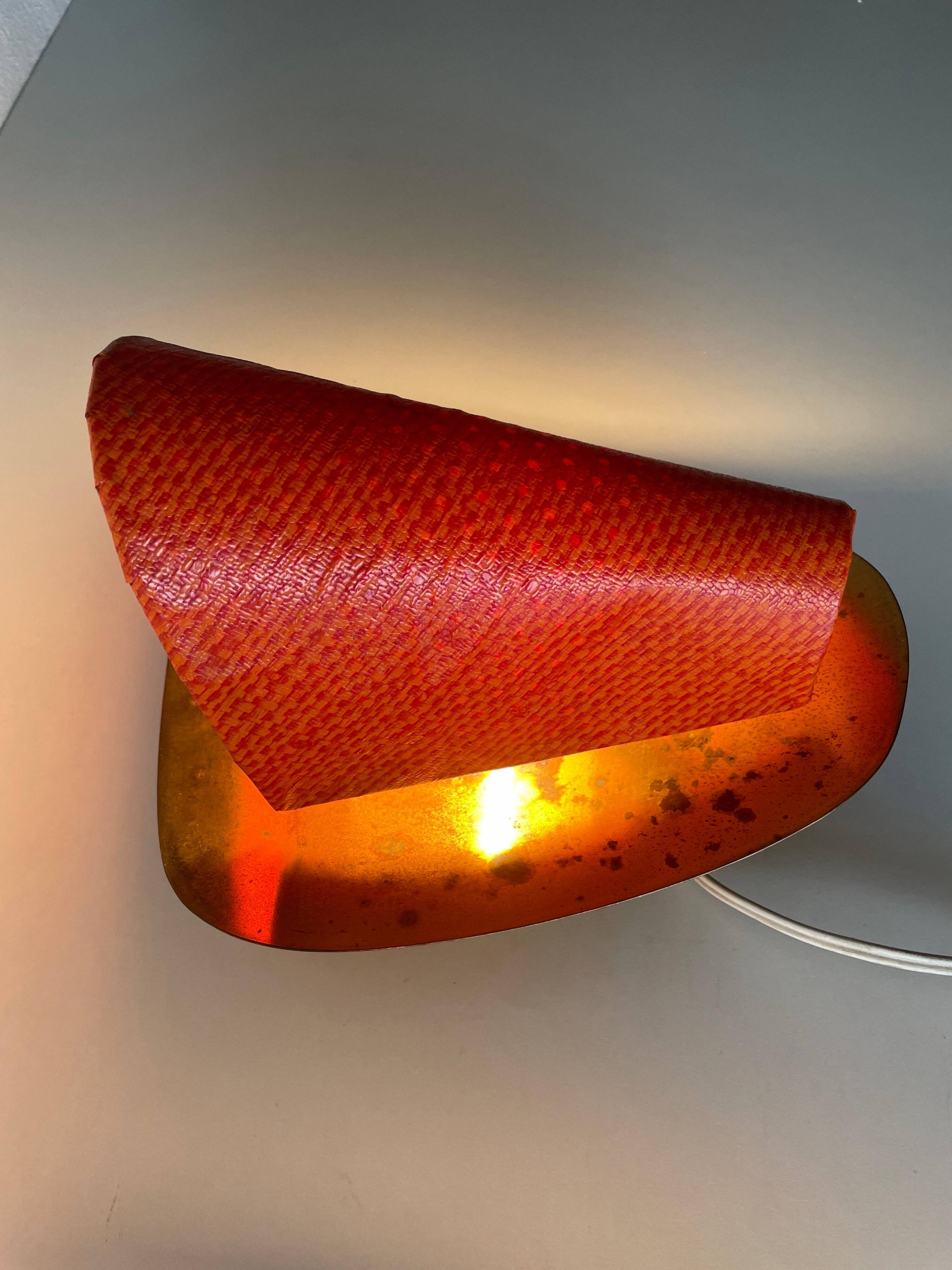 Pair of orange plexiglass and curved brass wall lights, 1950s, Germany
