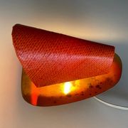 Pair of orange plexiglass and curved brass wall lights, 1950s, Germany