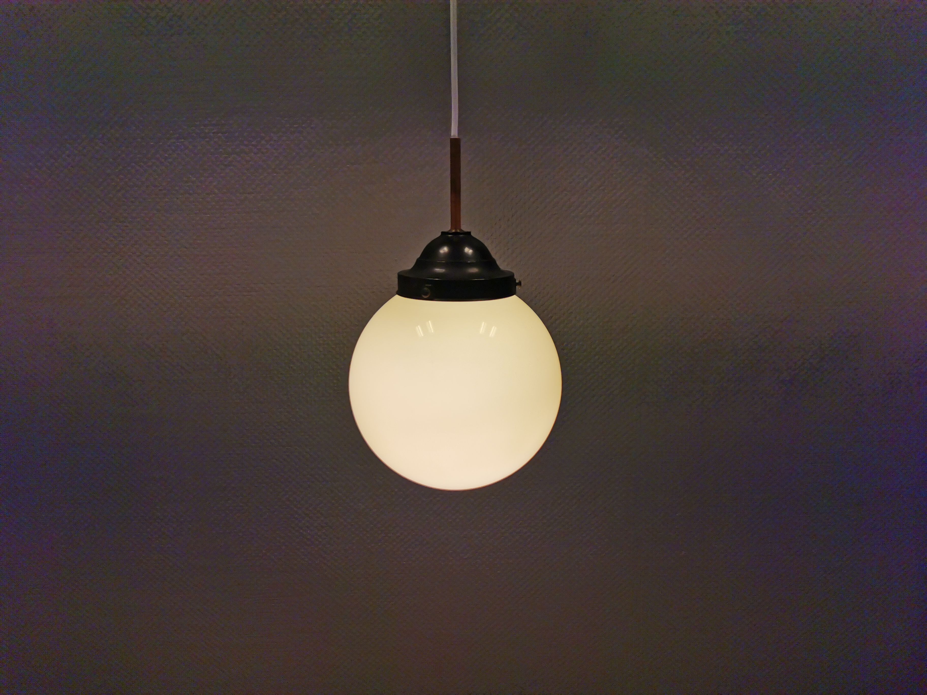 Small Art Deco hanging lamp in cream coloured glass and bakelite top.