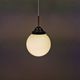 Small Art Deco hanging lamp in cream coloured glass and bakelite top.