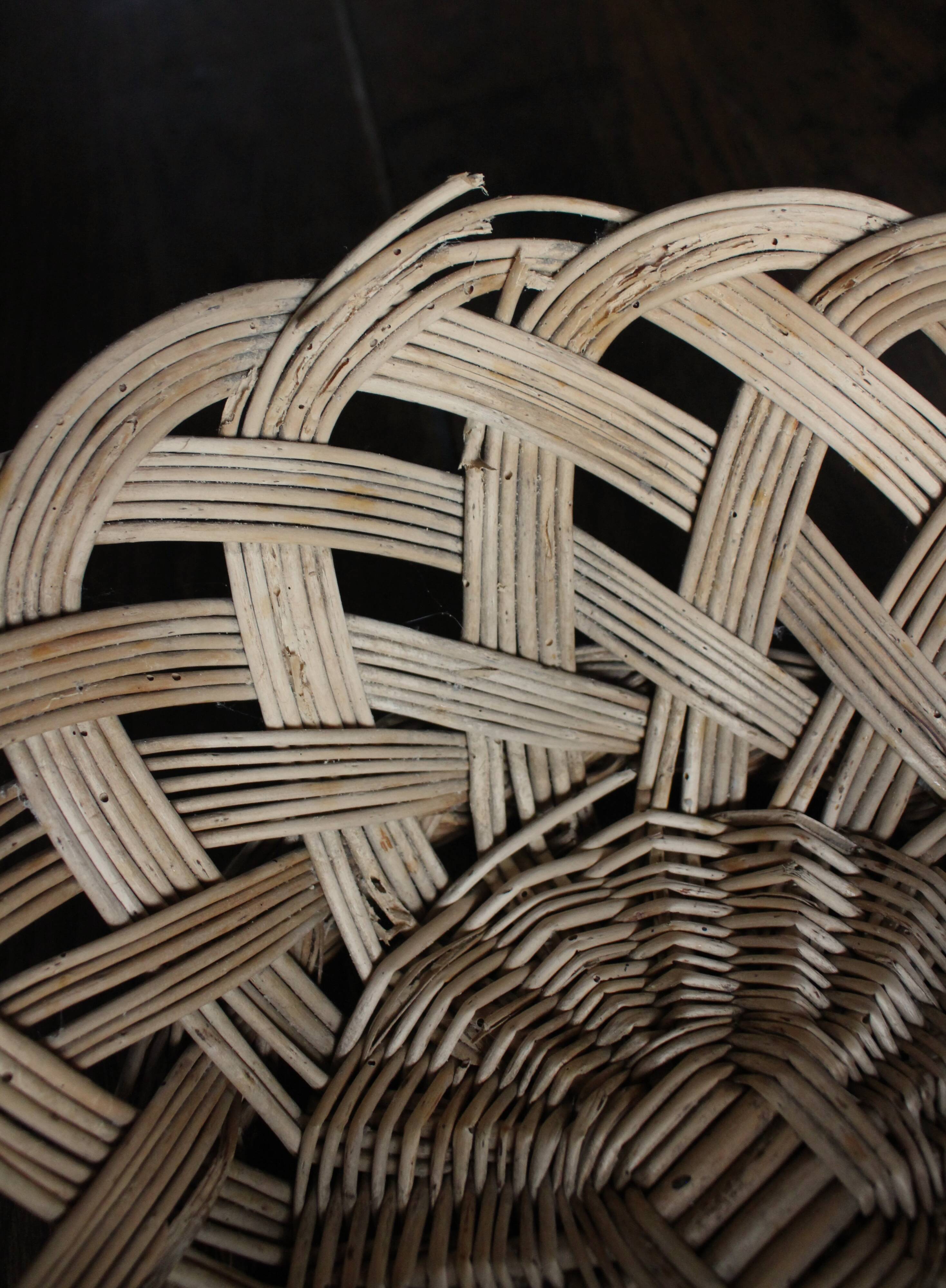 Large vintage twisted wicker basket on a stand