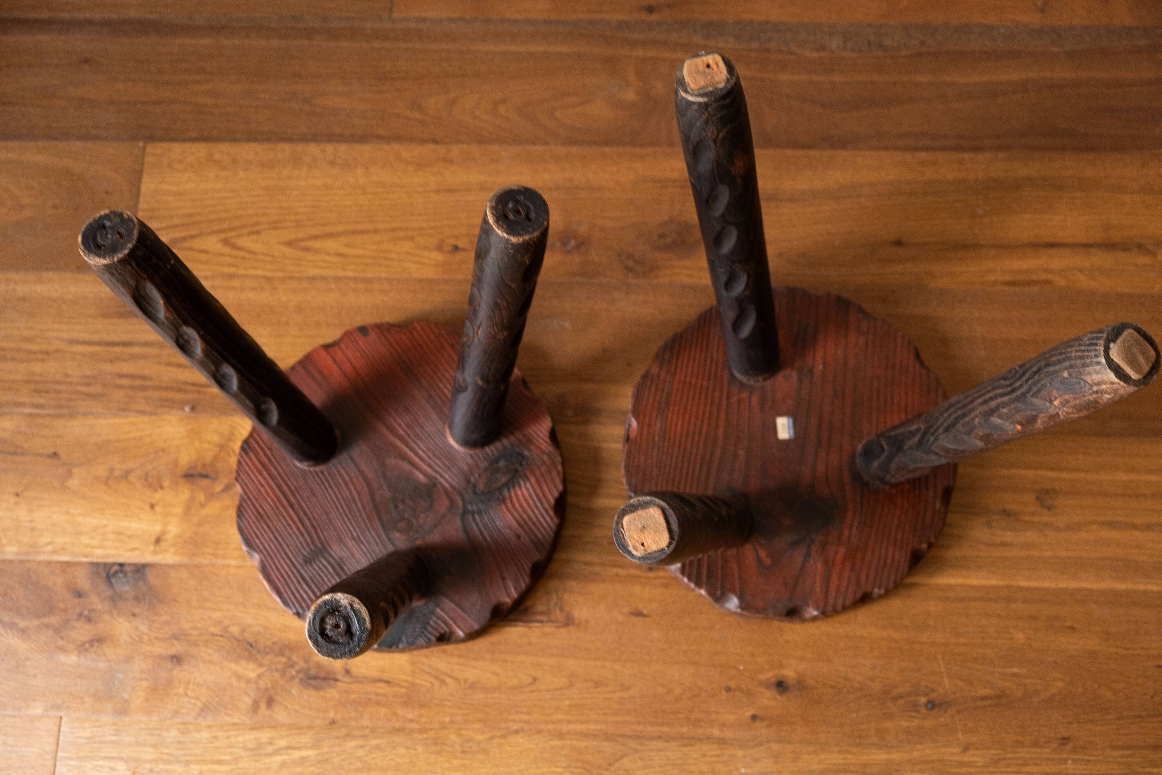 Set of two vintage round tripod stools, wooden farm stools.