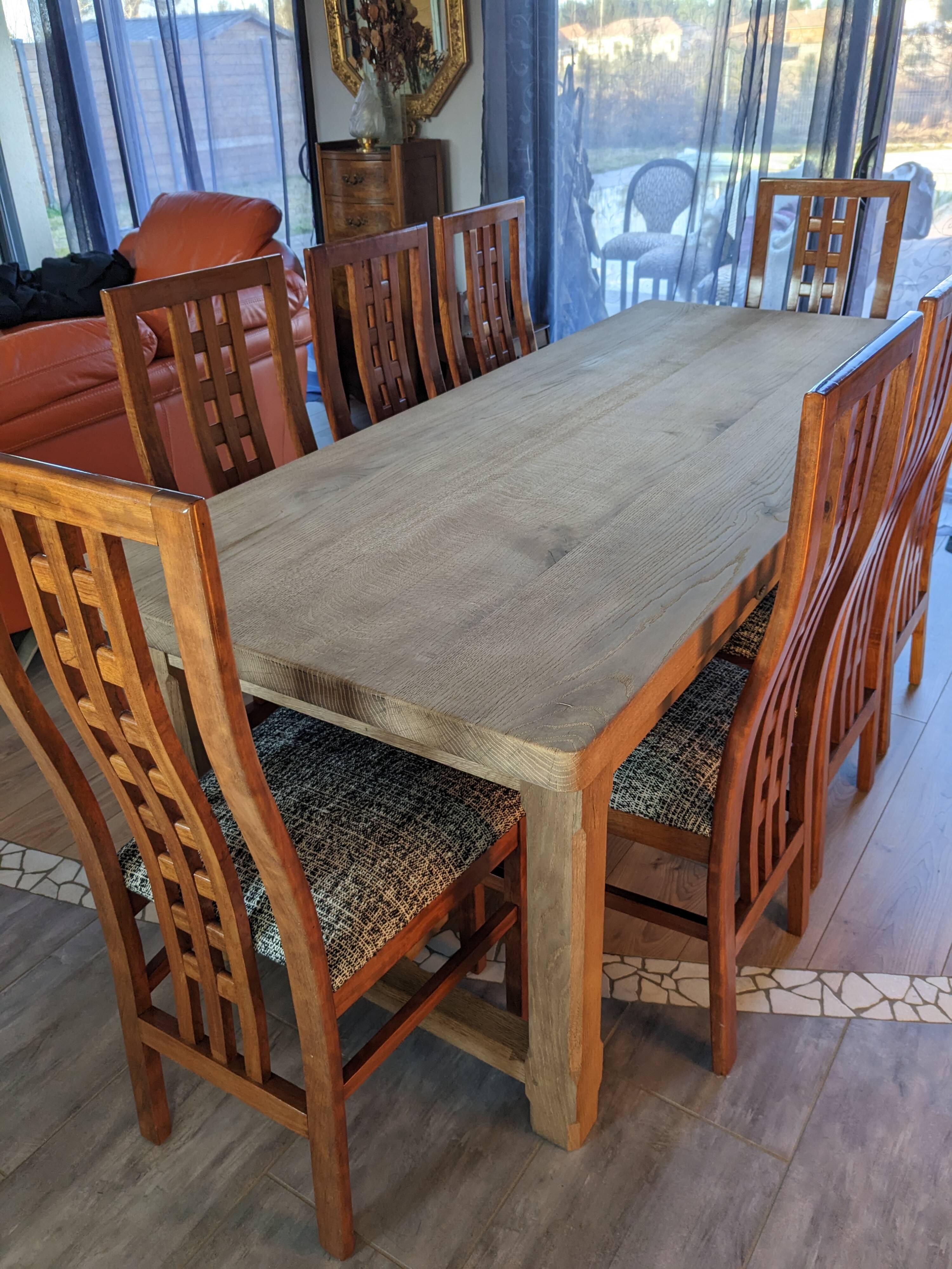 Set of 8 teak lounge chairs with high backs and zebra-striped seats