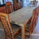 Set of 8 teak lounge chairs with high backs and zebra-striped seats