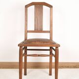 Art Deco style chair in carved wood and leather.
