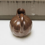 Old pitcher in glazed brown ceramic