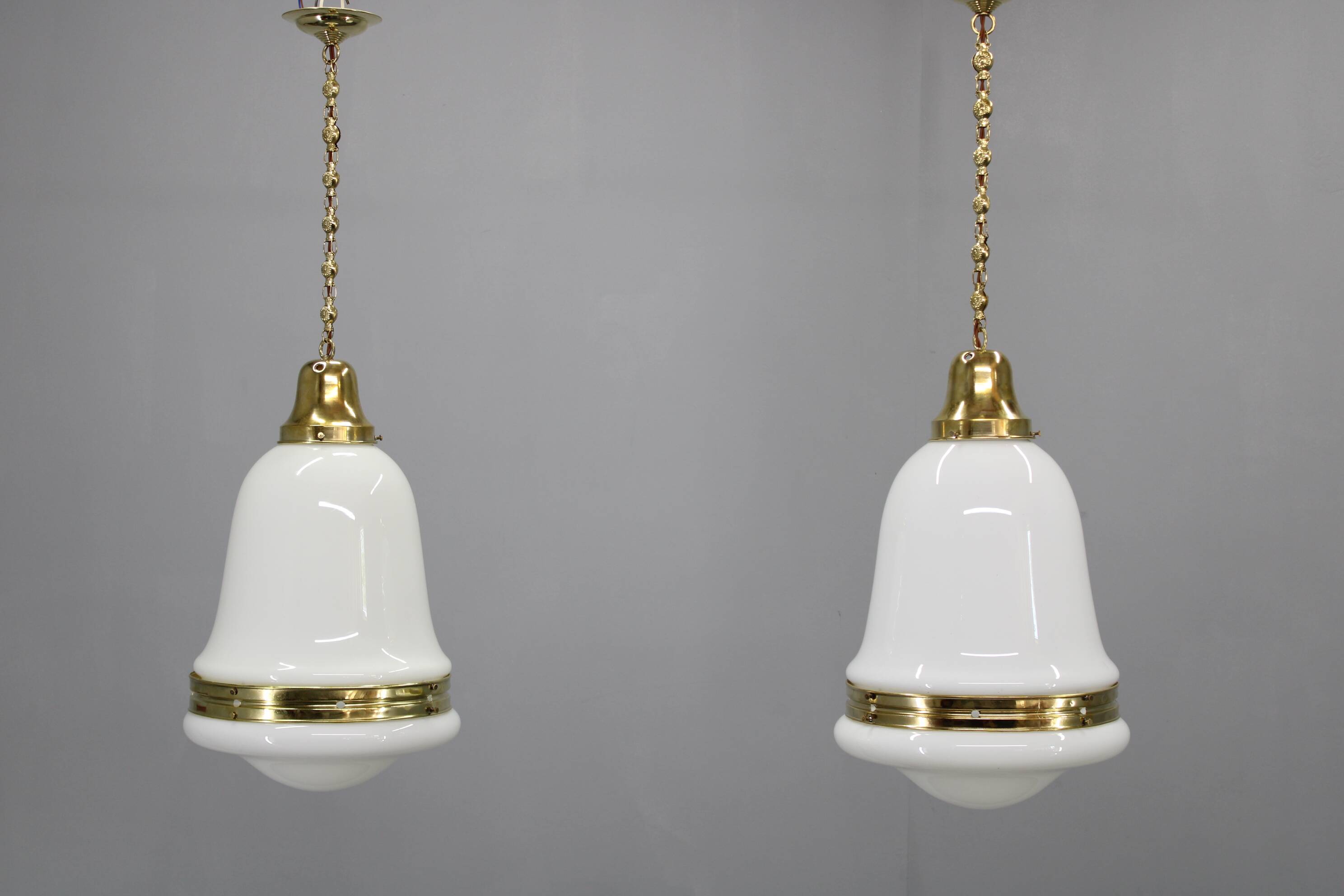 Pair of 1930s Peter Behrens Luzette pendants in opaline glass and brass