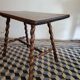 Brutalist coffee table with turned wooden legs