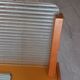 1950s coat rack with mirror, metal hooks, and glass shelf.