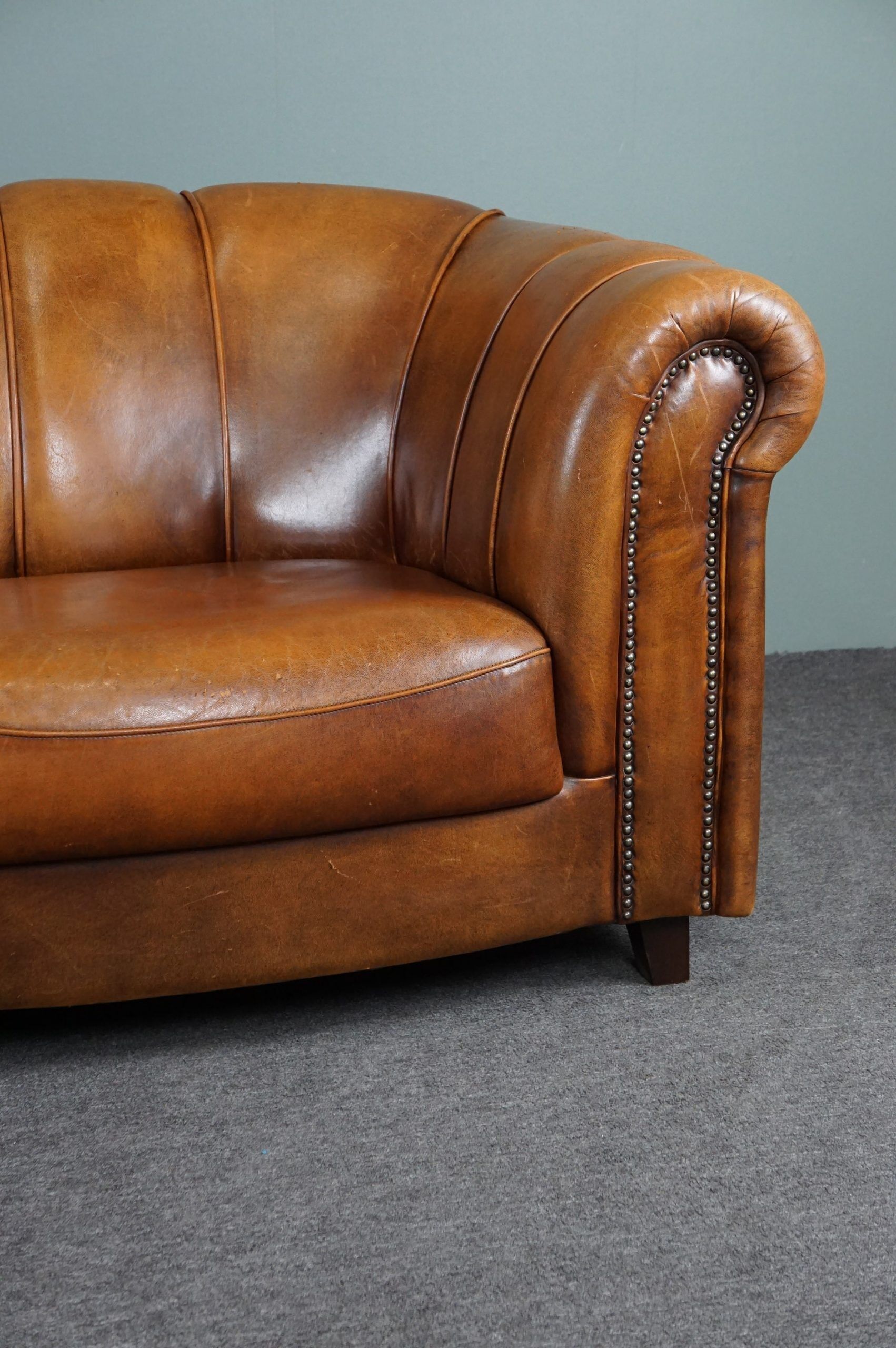 Sheepskin sofa with decorative nails