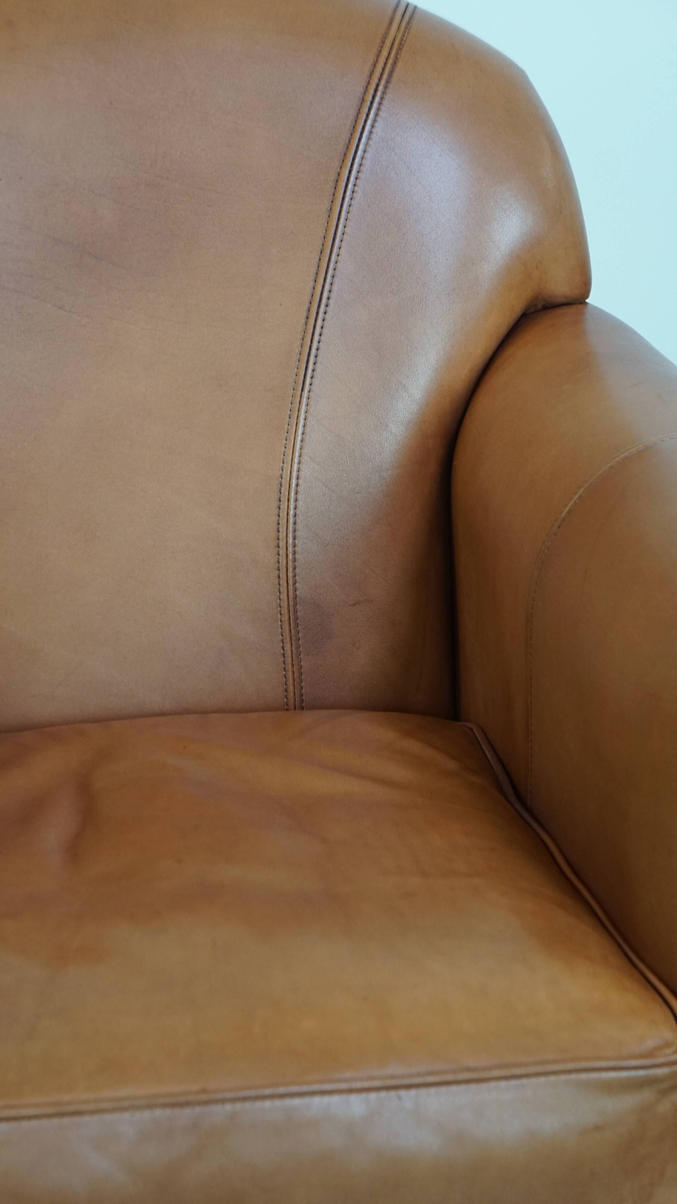 Cognac-colored cowhide leather armchair