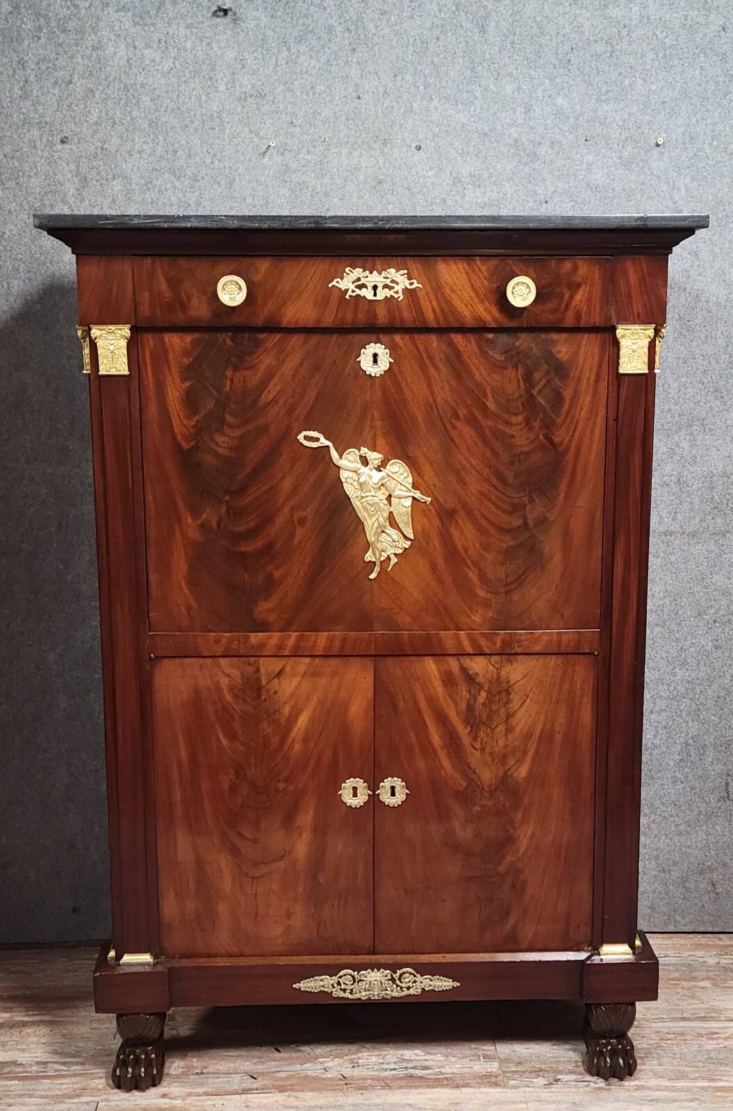 Rare four-column secretary from the Empire period in flame mahogany and bronze.