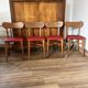 Set of 4 wooden chairs with red vinyl.