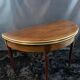 A Louis XVI period mahogany half-moon table forming a console/games table