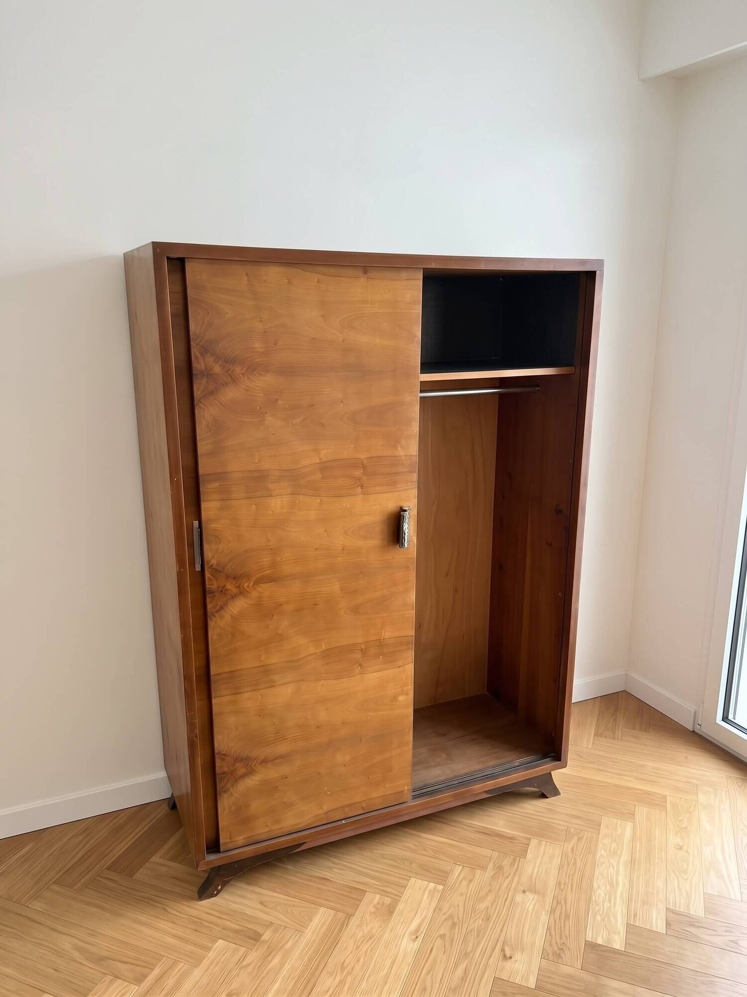 Vintage 1950s wardrobe with sliding wooden doors.