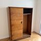Vintage 1950s wardrobe with sliding wooden doors.