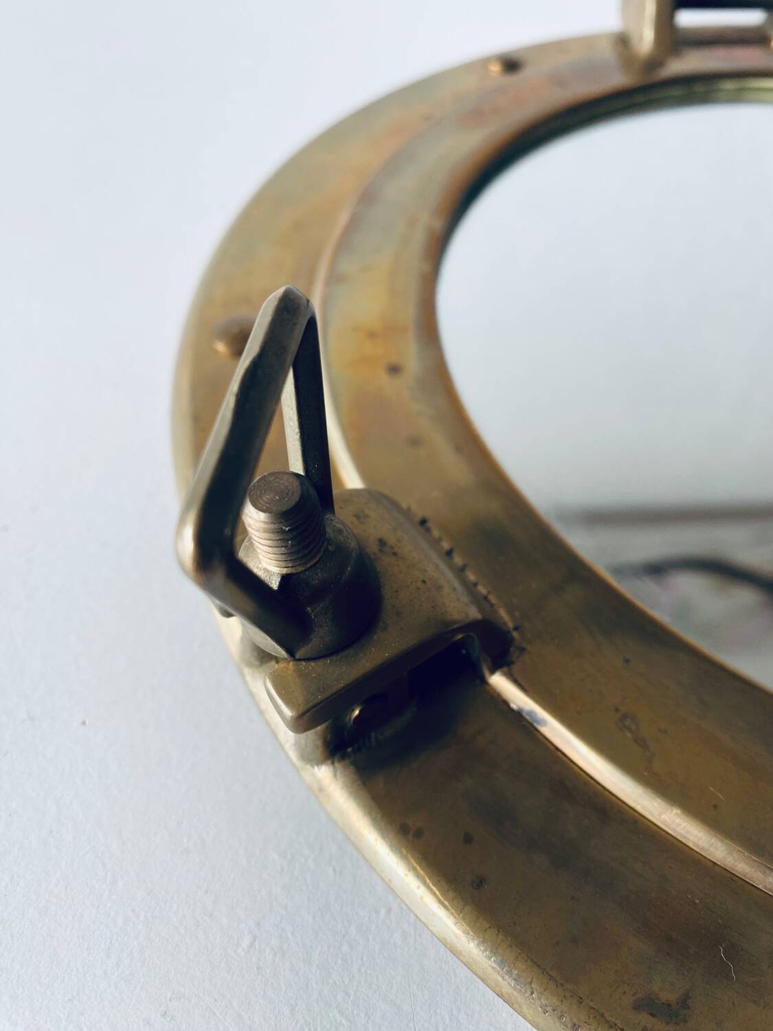 Porthole mirror in gilded brass