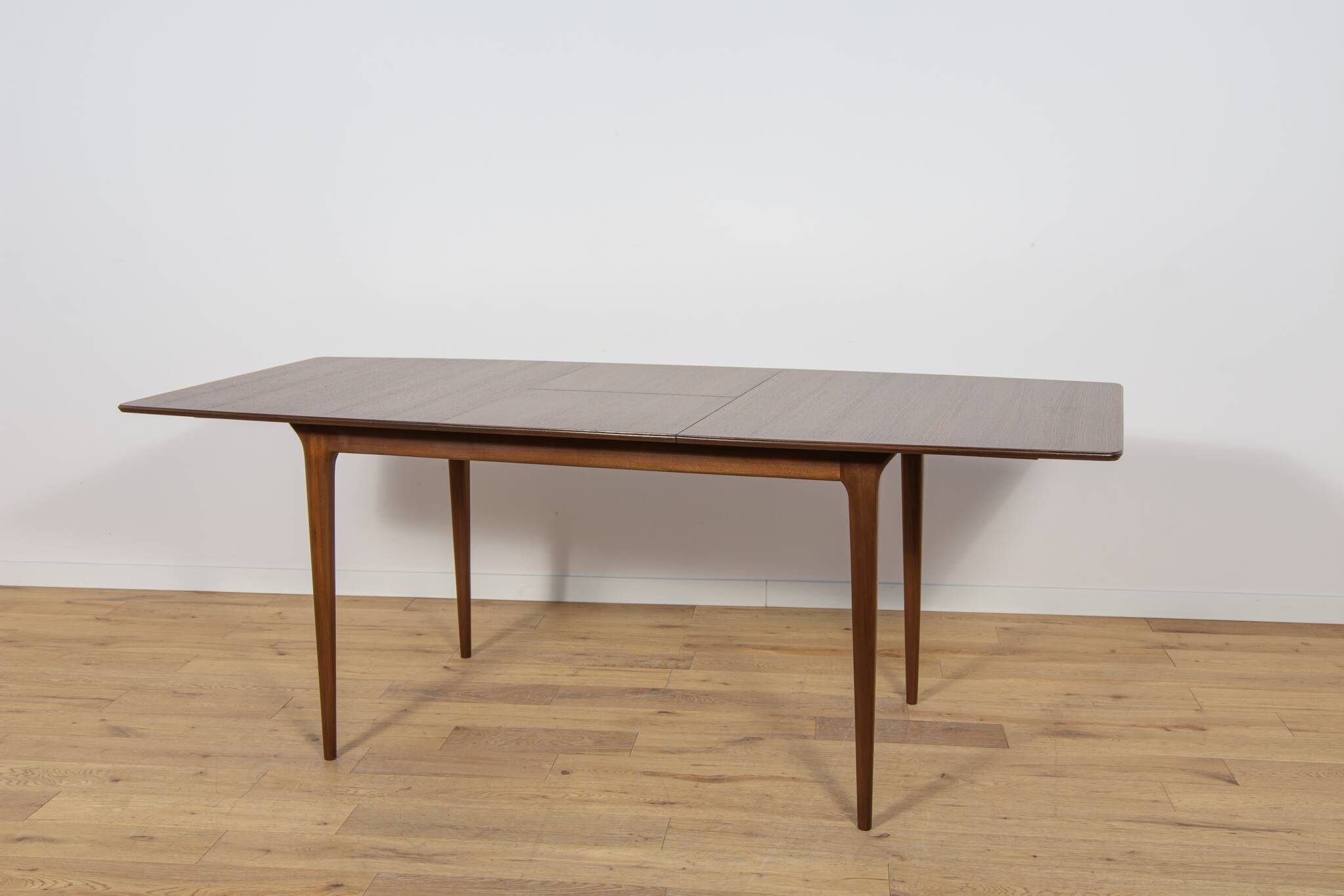 Extendable teak dining table in Mid-Century style from McIntosh, UK.