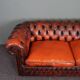 Chesterfield sofa in patinated orange leather, 2.5 seats
