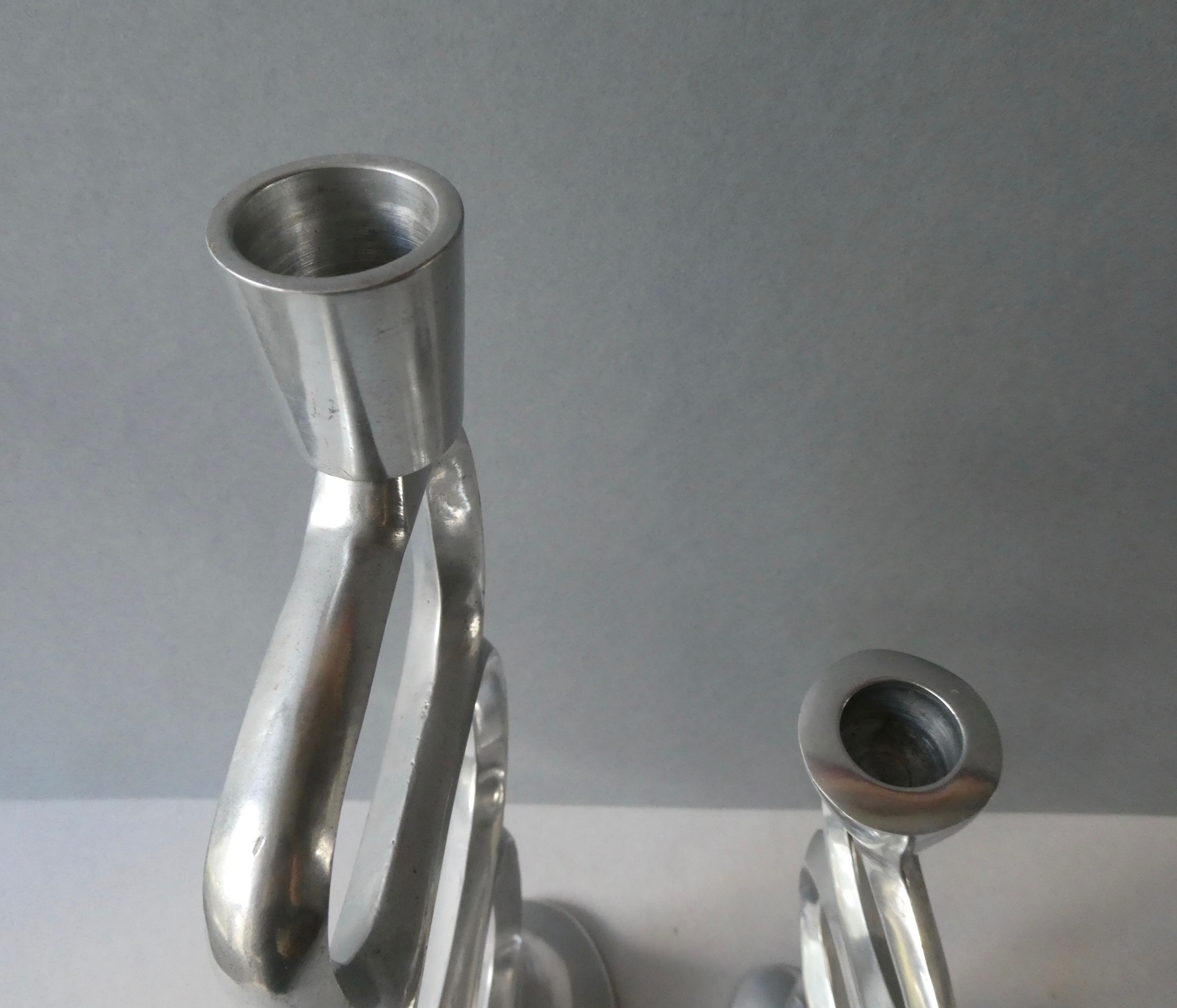 Pair of cast aluminum candle holders, design