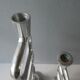 Pair of cast aluminum candle holders, design