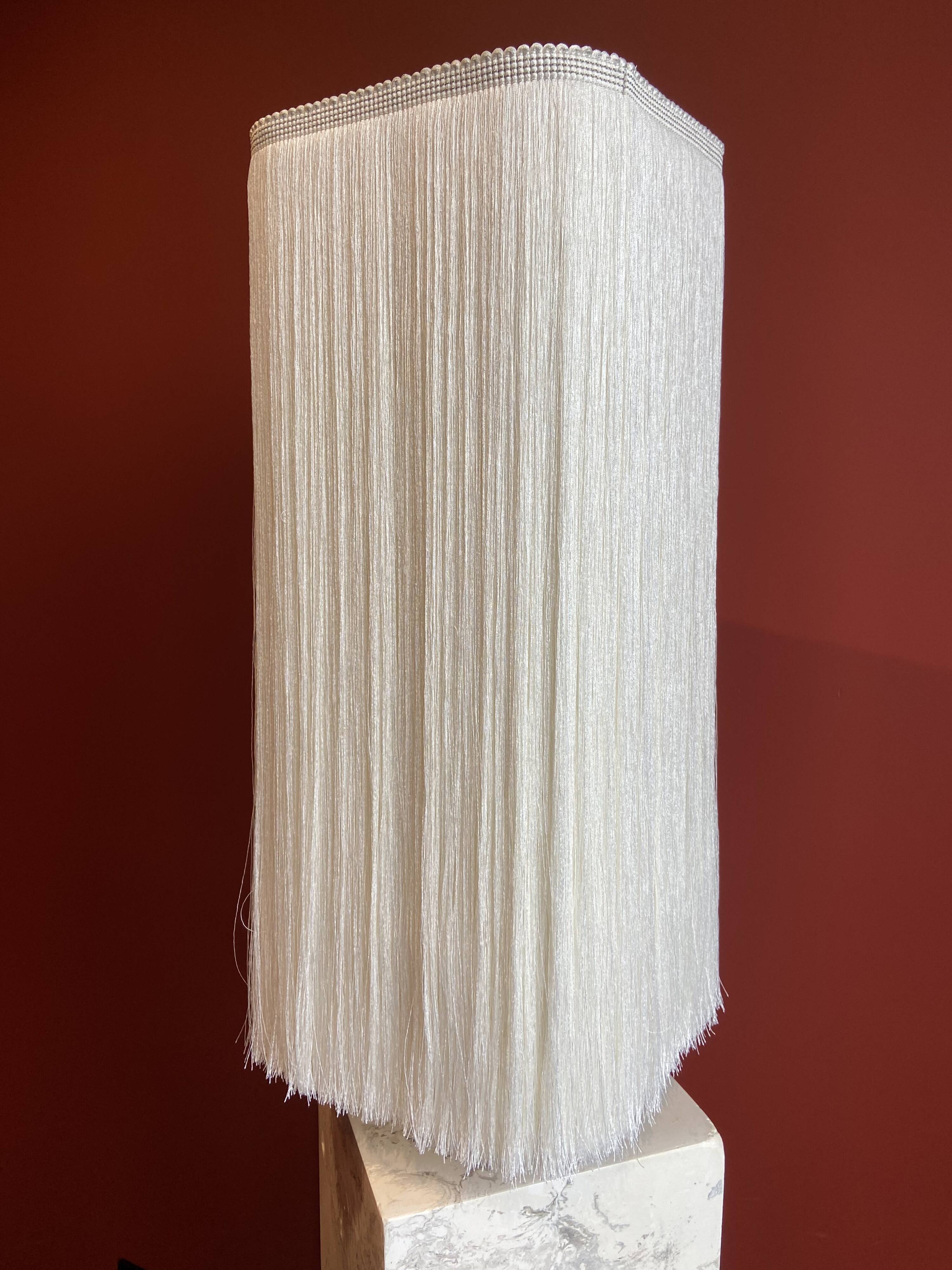 Beige marble stucco base, Houles white ecru fringed lampshade.