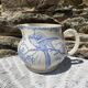 Earthenware pitcher decorated with birds.