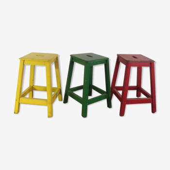 Three wooden stools with a handle