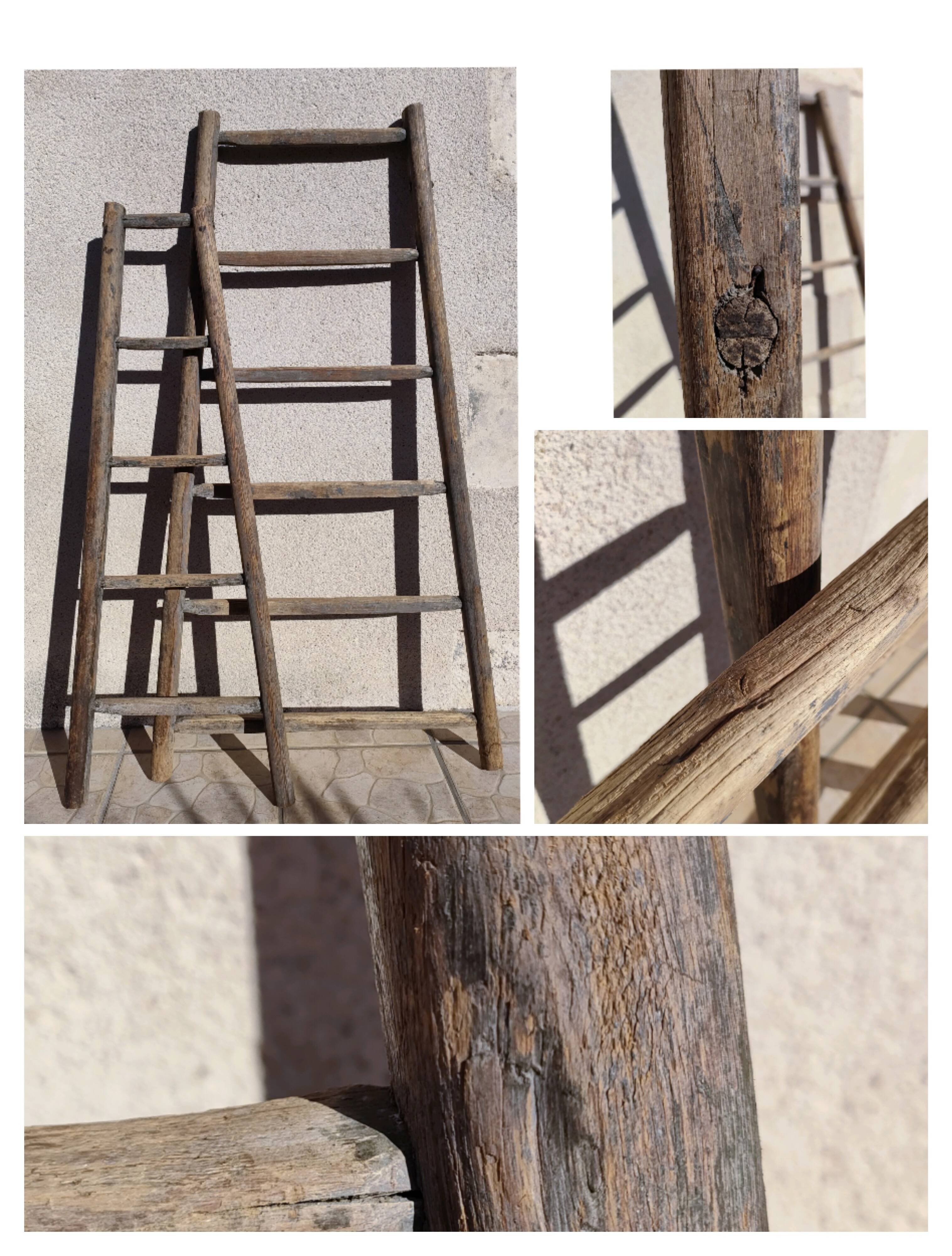 Two weathered wooden ladders H.135 cm