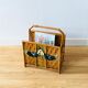 Vintage rattan magazine holder with floral decoration