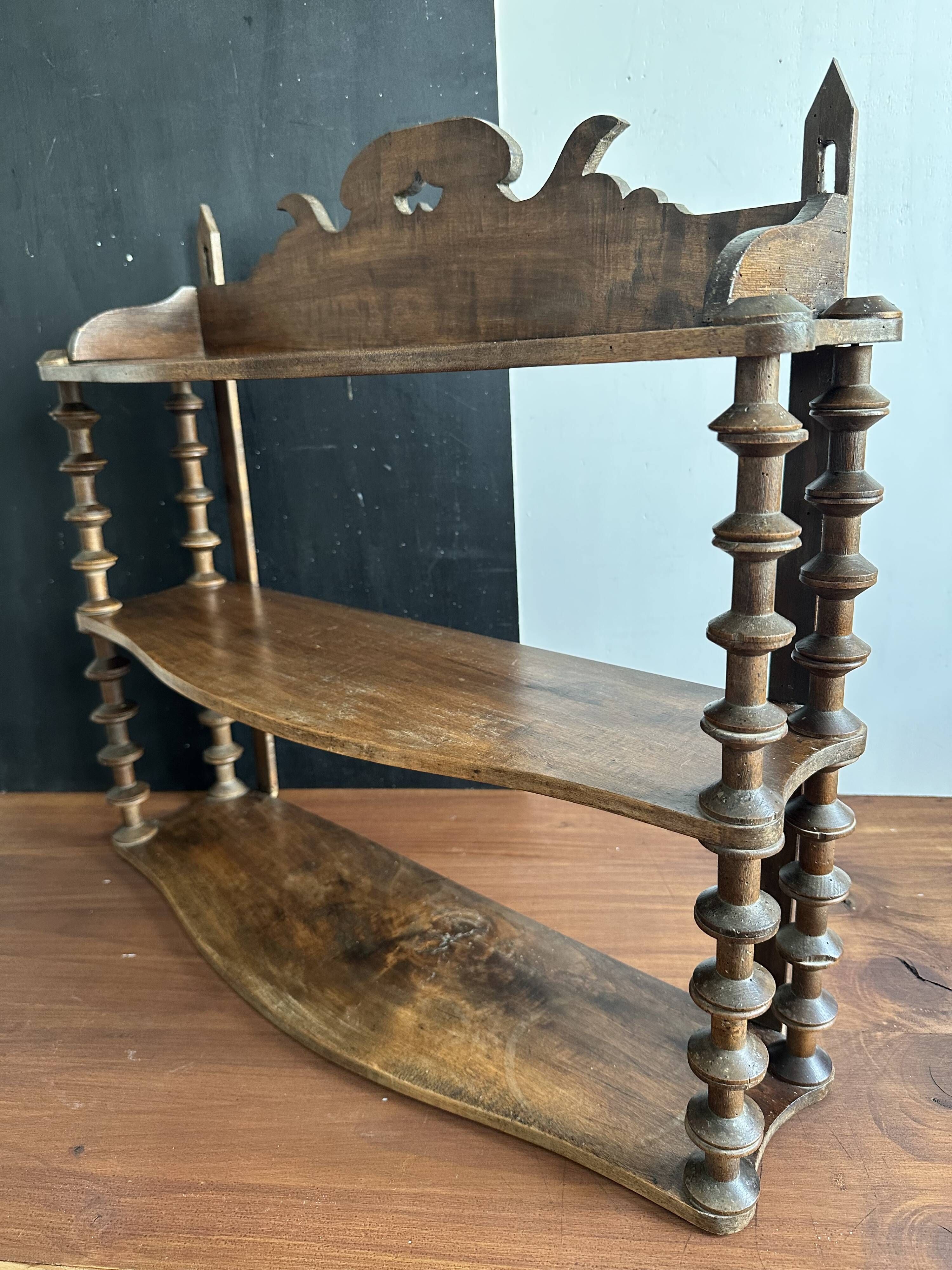Antique wall shelf made of turned wood and spools of thread, late 19th century.