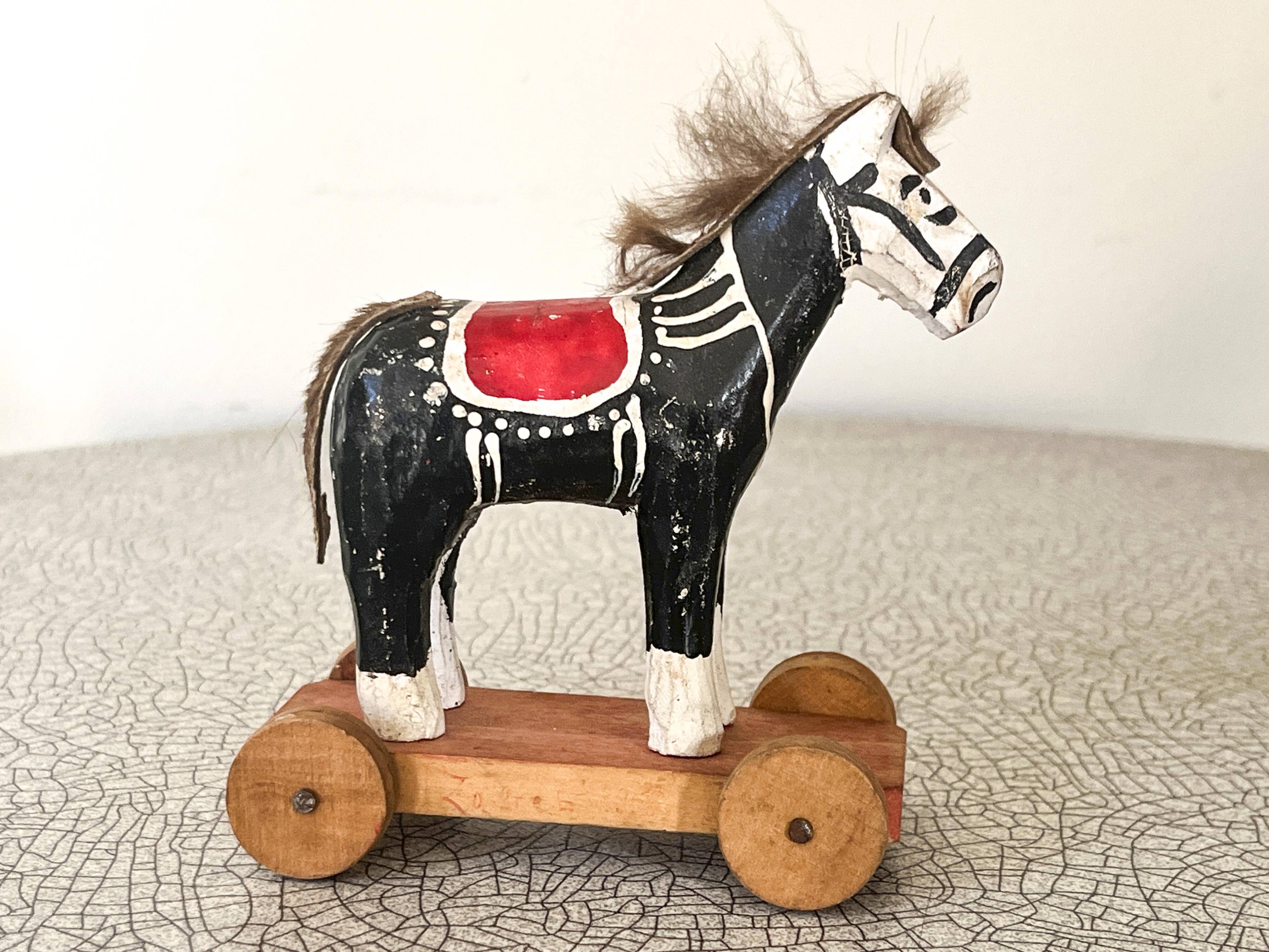 Old wooden pull-along toy, horse.