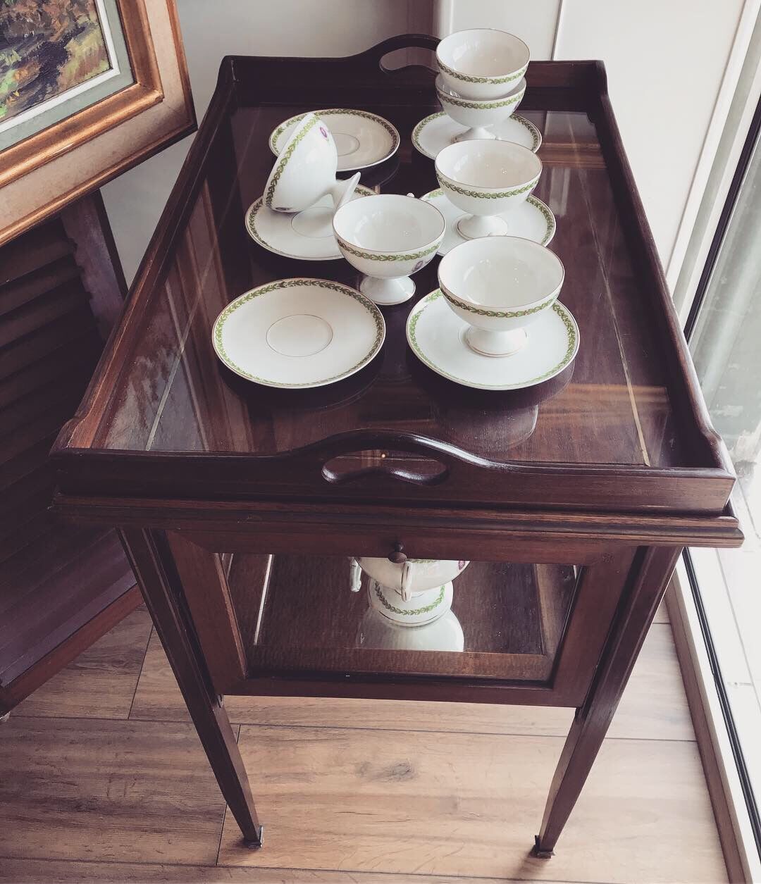 Glass-enclosed old tea table with wooden tray, bronze and brass