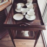 Glass-enclosed old tea table with wooden tray, bronze and brass