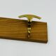 Vintage wall coat rack in brass and wood design.