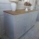 Vintage low sideboard with 3 doors, pearl gray patina, wooden top.
