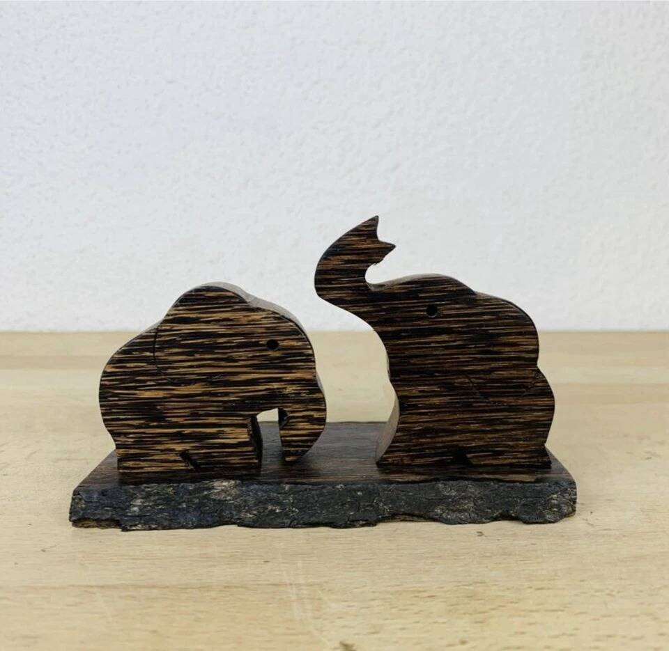 Vintage palm wood elephant salt and pepper shakers.