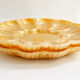 Pair of iridescent orange glass egg plates