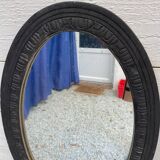 Old oval mirror with slate-coloured patina