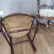 Pair of Provençal armchairs in brown wood and floral fabric.