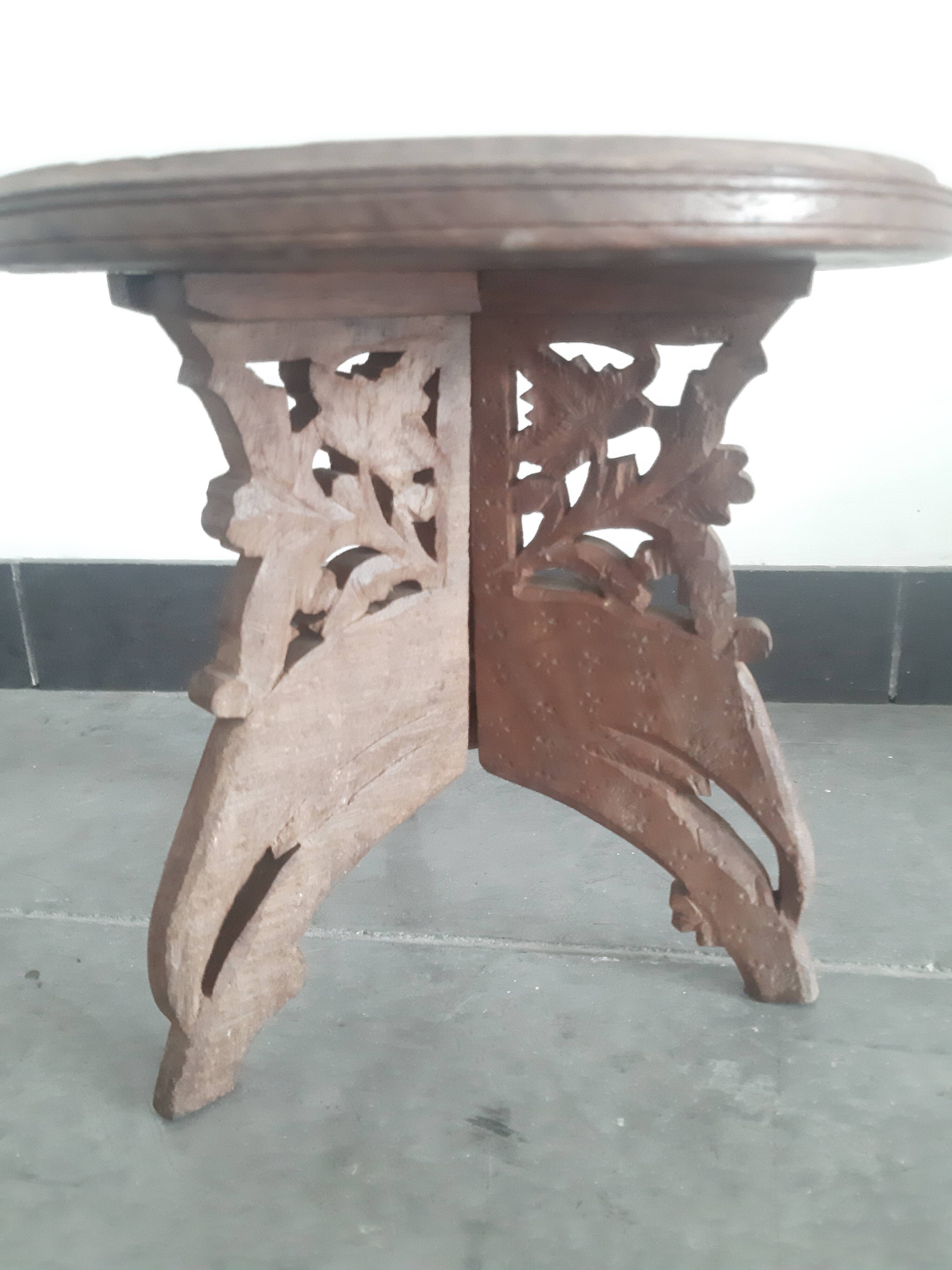 Carved wooden hunting stool decorated with vines