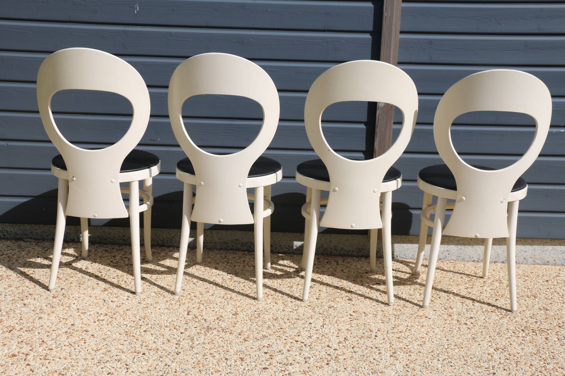 6 baumann chairs, white gull with black faux leather.