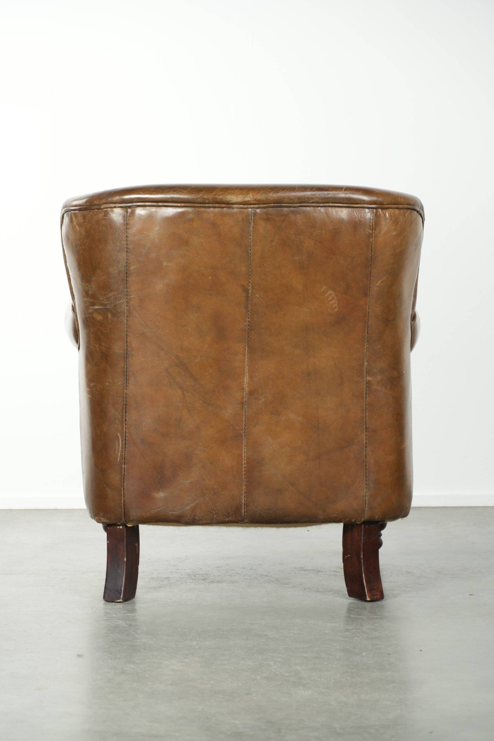 Robust cowhide armchair in a beautifully subtle size with a wonderful patina.