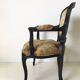 Black baroque armchair with fabric designed by wildlife by Ascension Latorre, Spain