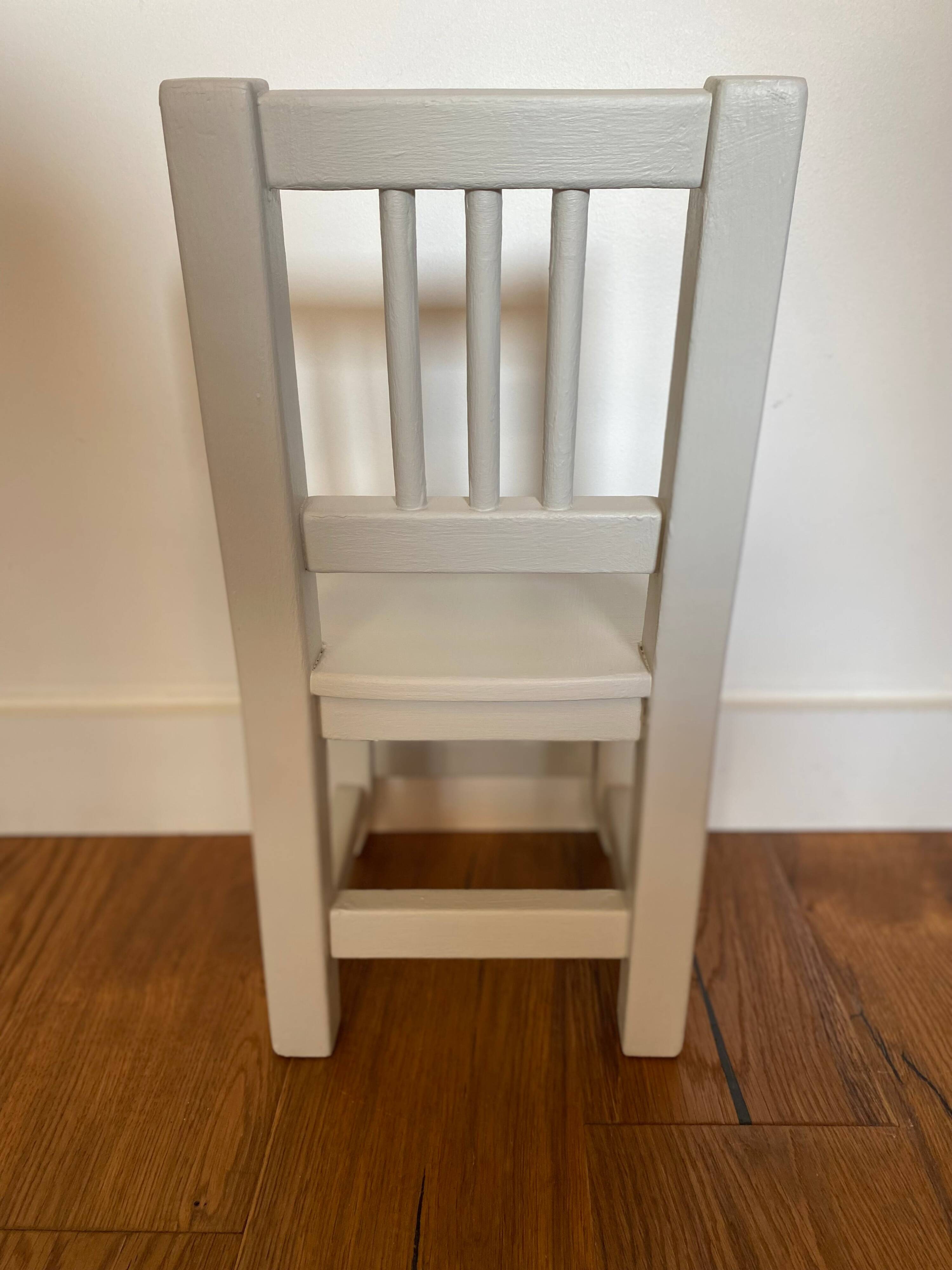 Small children's chair in antique white wood.