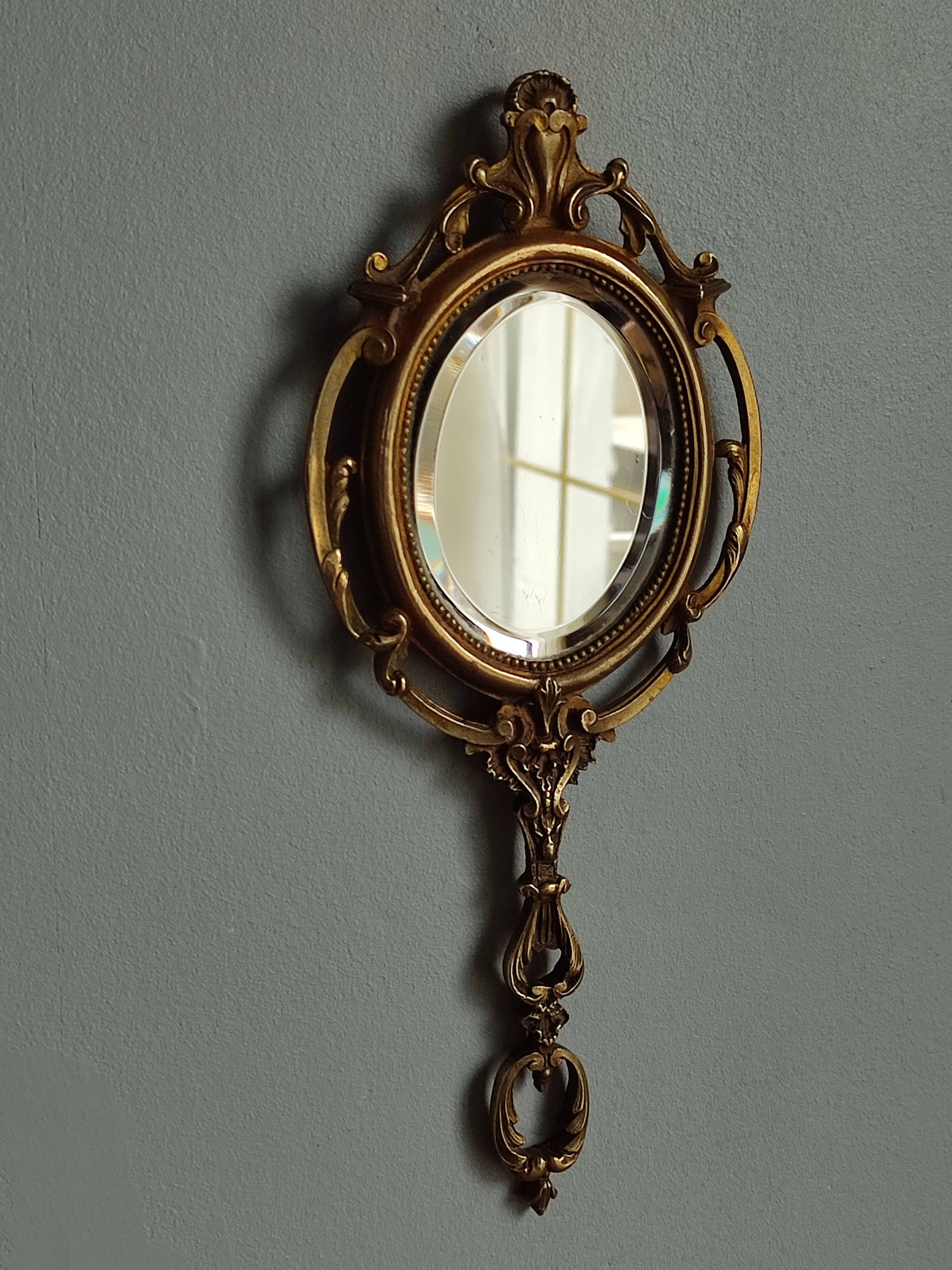 Antique hand-facing mirror in bronze and beveled glass