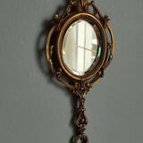 Antique hand-facing mirror in bronze and beveled glass